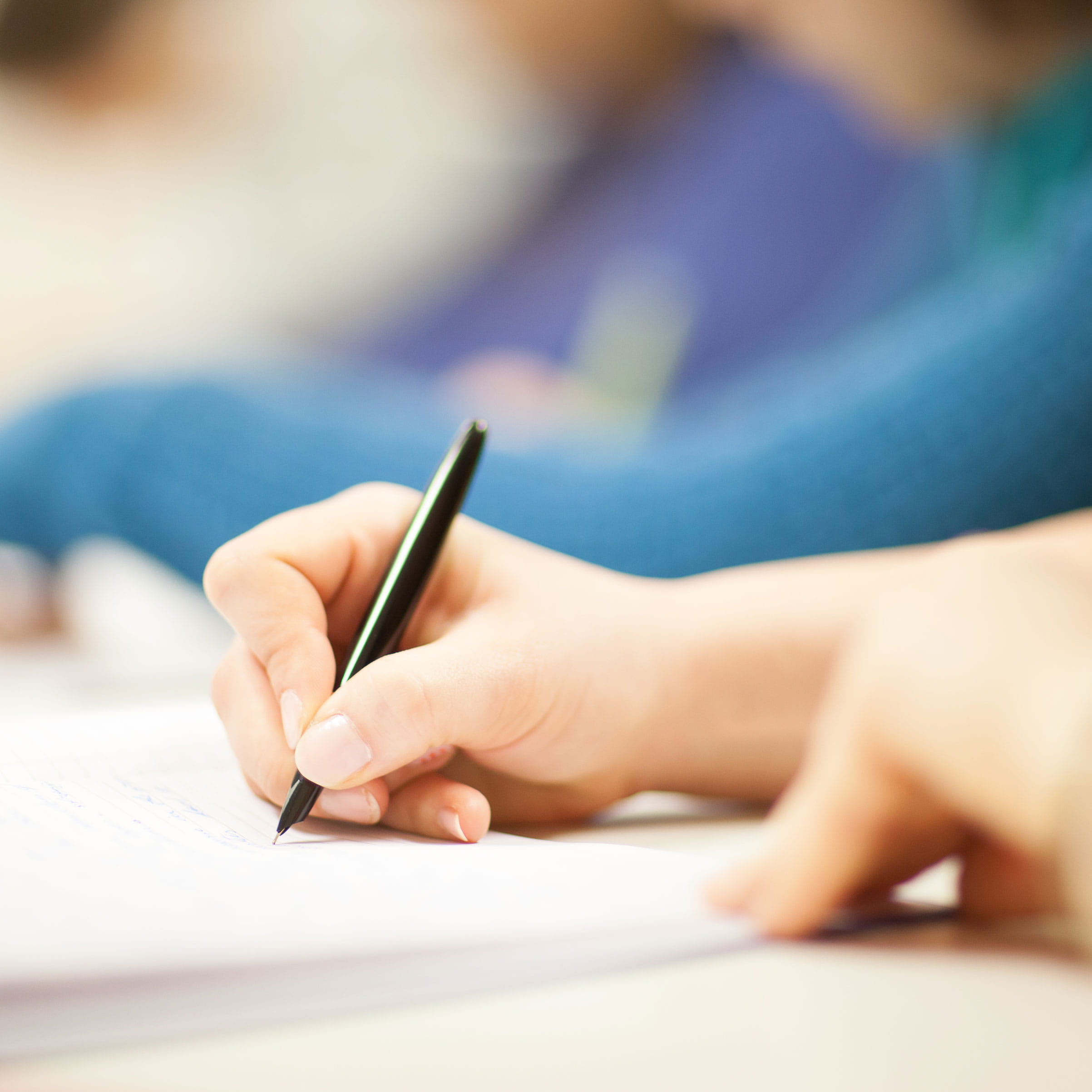 A hand writing on paper