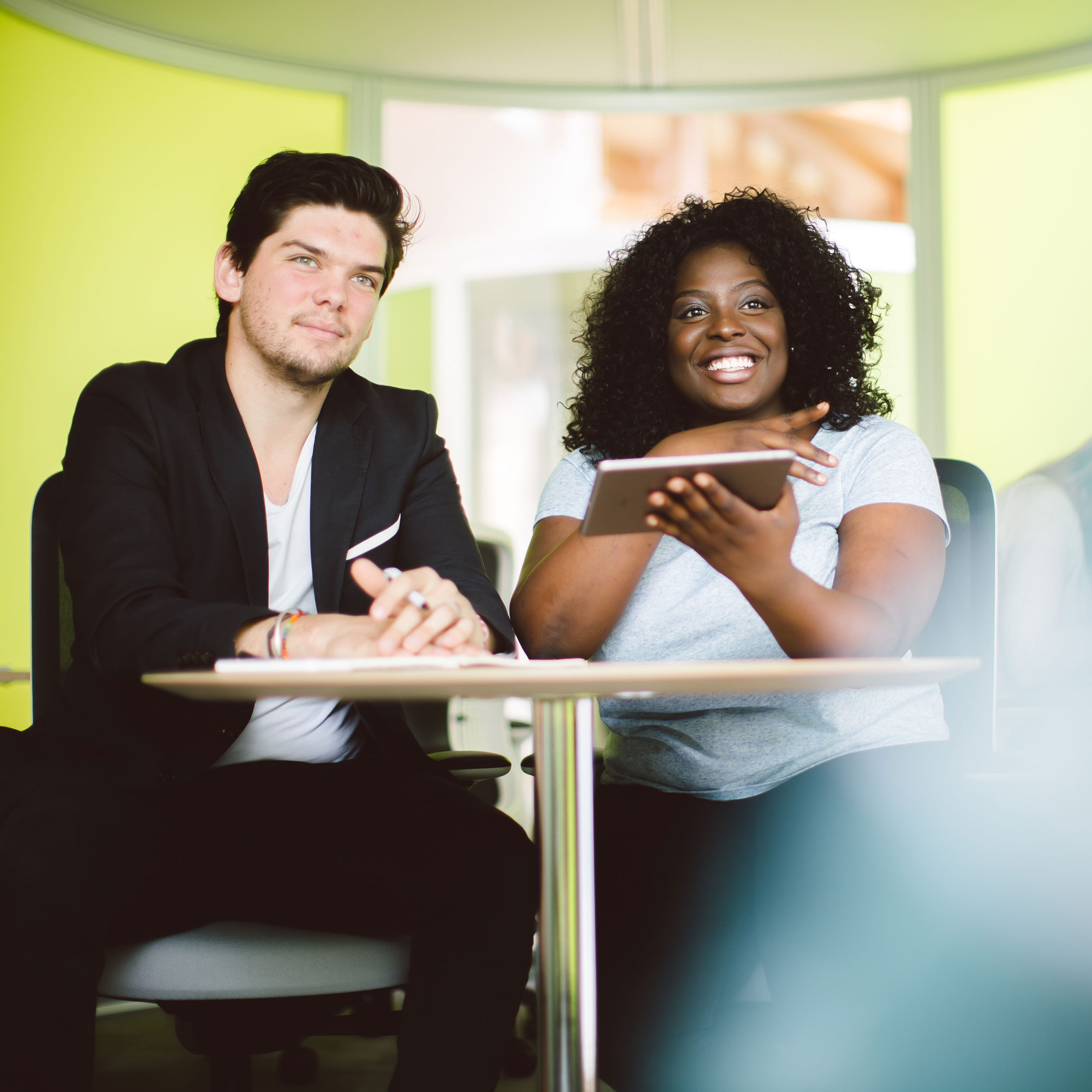 Two students using iPad looking at screen