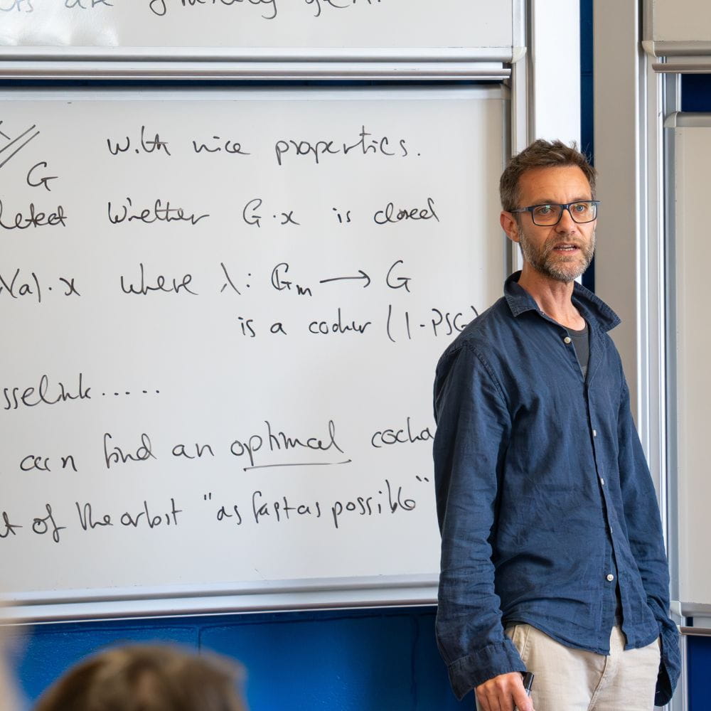 A lecturer addresses a crowded room