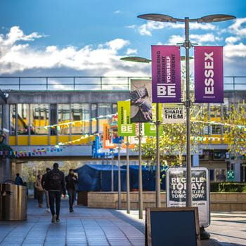 A sunny day with banners flying on Colchester Campus Square 4. 