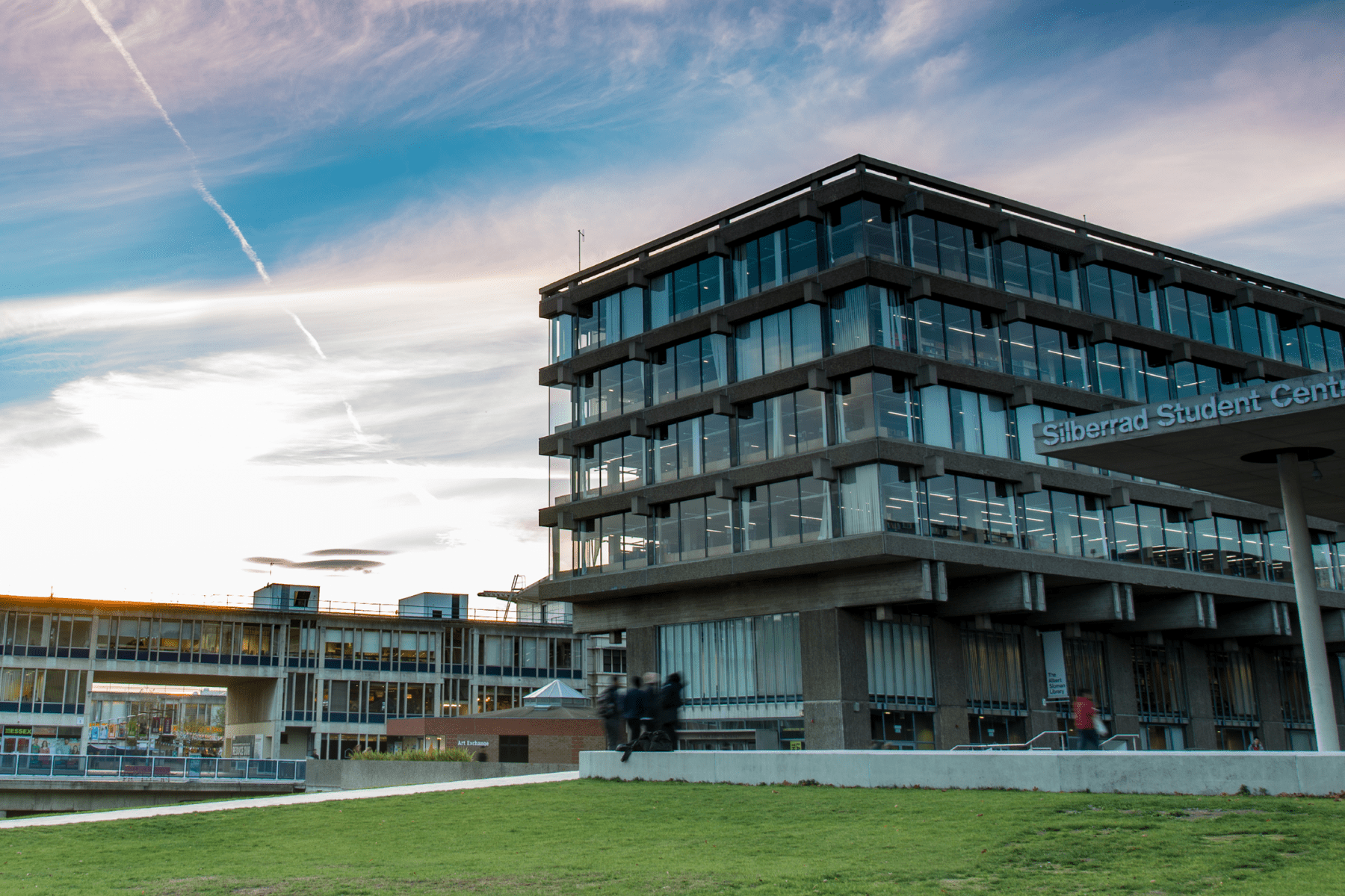 Landscape view of the university library with blue skies and square 5 in the background
