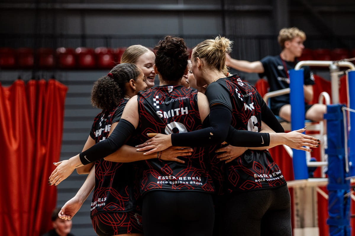 Essex Rebels womens volleyball team embrace on court mid-game at Essex Sport Arena 2025-26 season